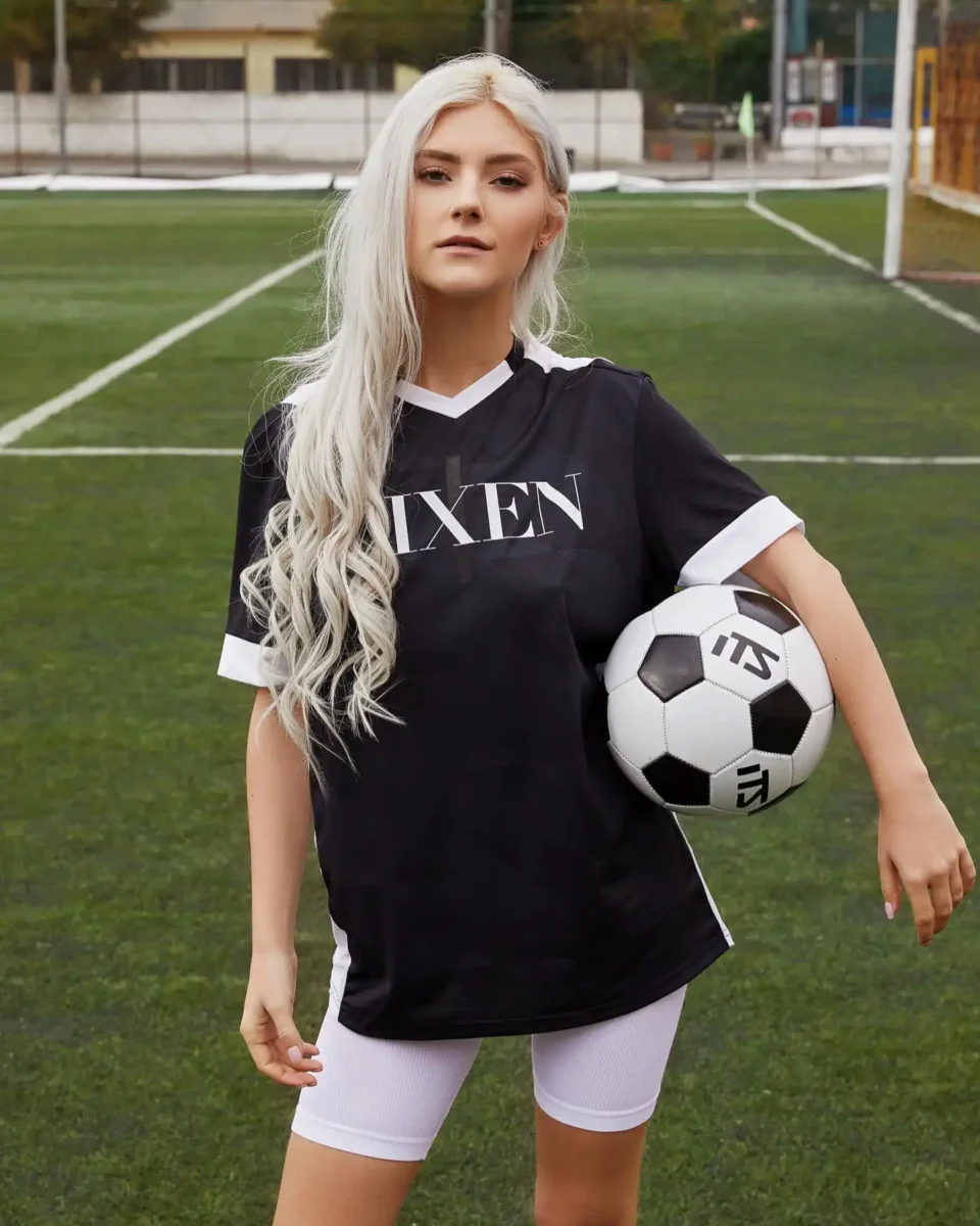 Eva Elfie in Football dress with a football in hand 